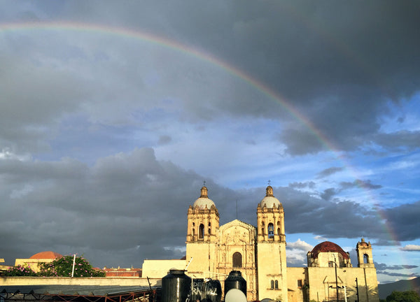 view of santo domingo cathedral with a rainbow in the background.