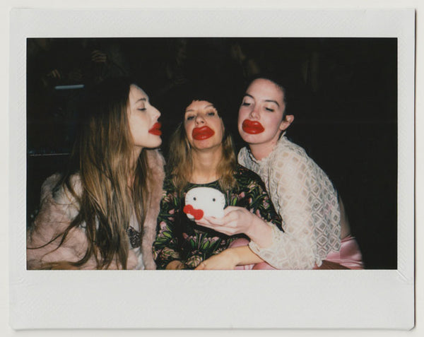 people wearing fake red lips, posing - polaroid style. 