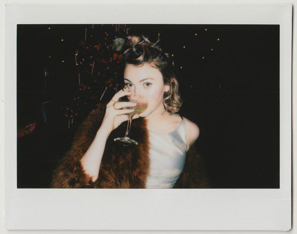 employee posing, having a drink - polaroid style. 