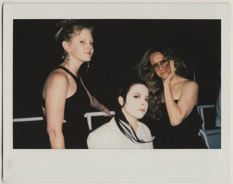 three employees posing to the camera - polaroid style.