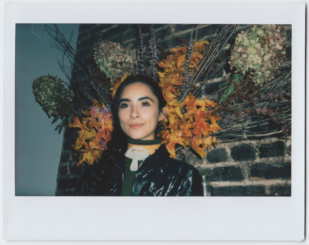 person smiling with floral embellishment in the background - polaroid style. 