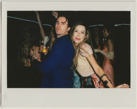 employees posing to the camera on the dance floor - polaroid style.