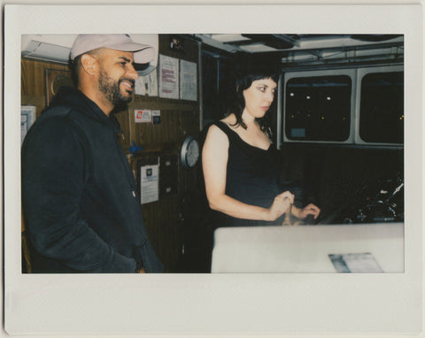 employees navigating the helm of the boat - polaroid style.