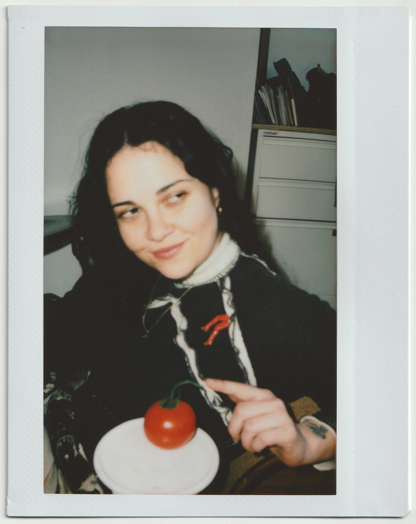 portrait of chelsea and a tomato.