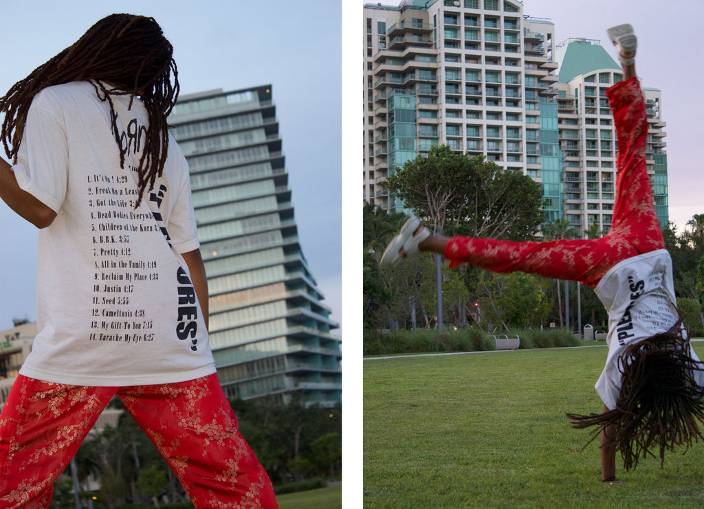 left to right: person with korn t-shirt back to camera, and a person making cartwheel.