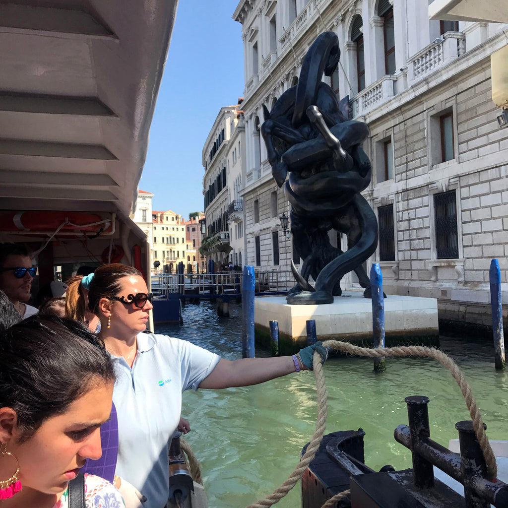 a group of people on a boat in venice.