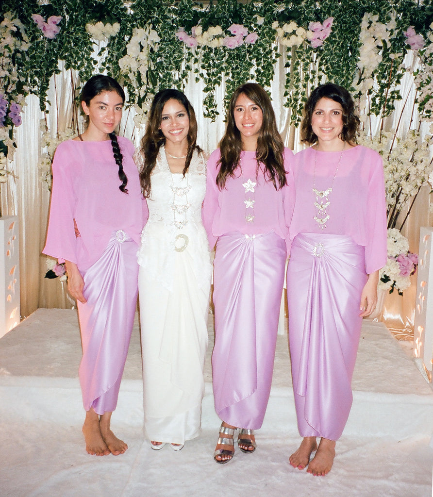 a group of people in pink at traditional malay wedding. 