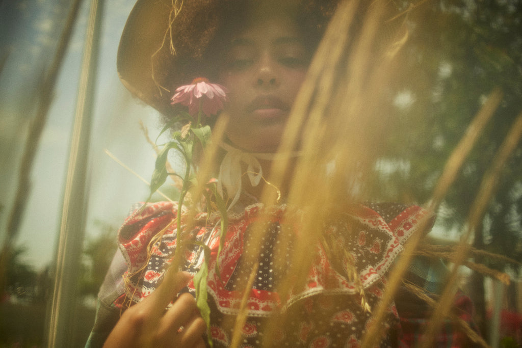 model portrait out of focus with flower.