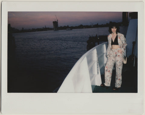 employee posing with the sunset in the background, full body shot - polaroid style.