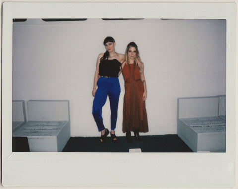 employee duo posing to the camera, full body shot - polaroid style.