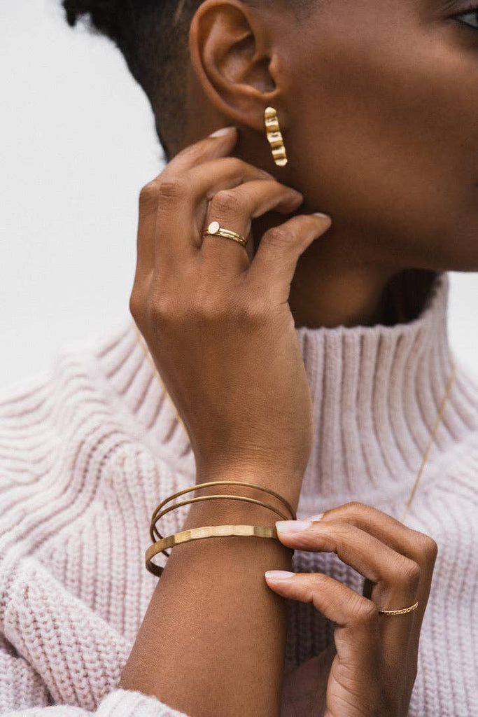 detail shot of ring, earring, and bracelets.