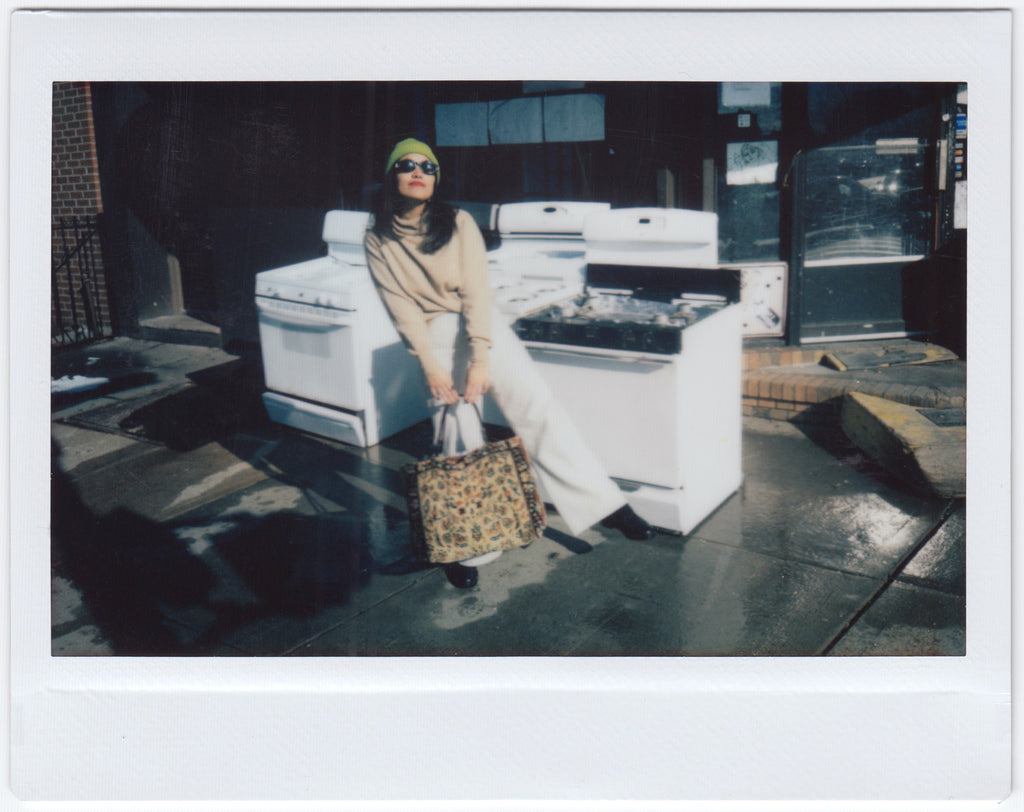 ana posing with stoves on sidewalk.