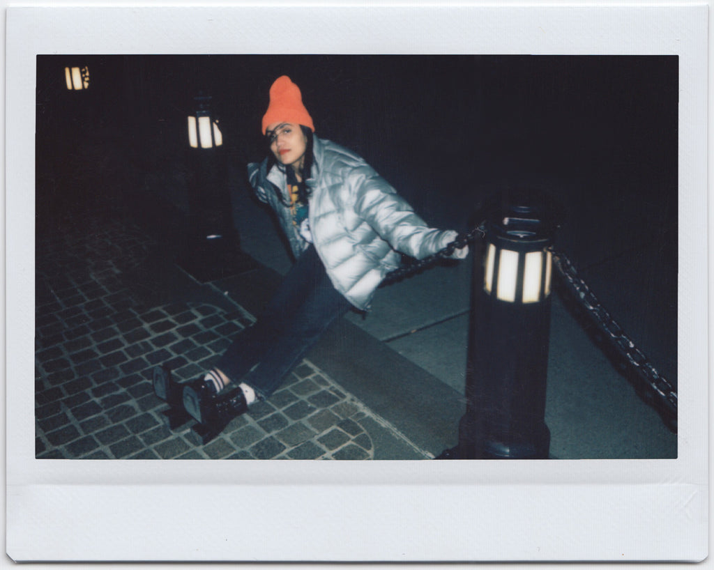 ana sitting on chain link.