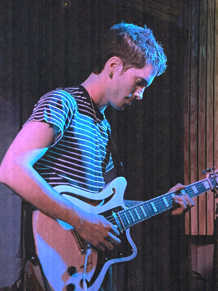 ok, tyler playing guitar in striped t-shirt.