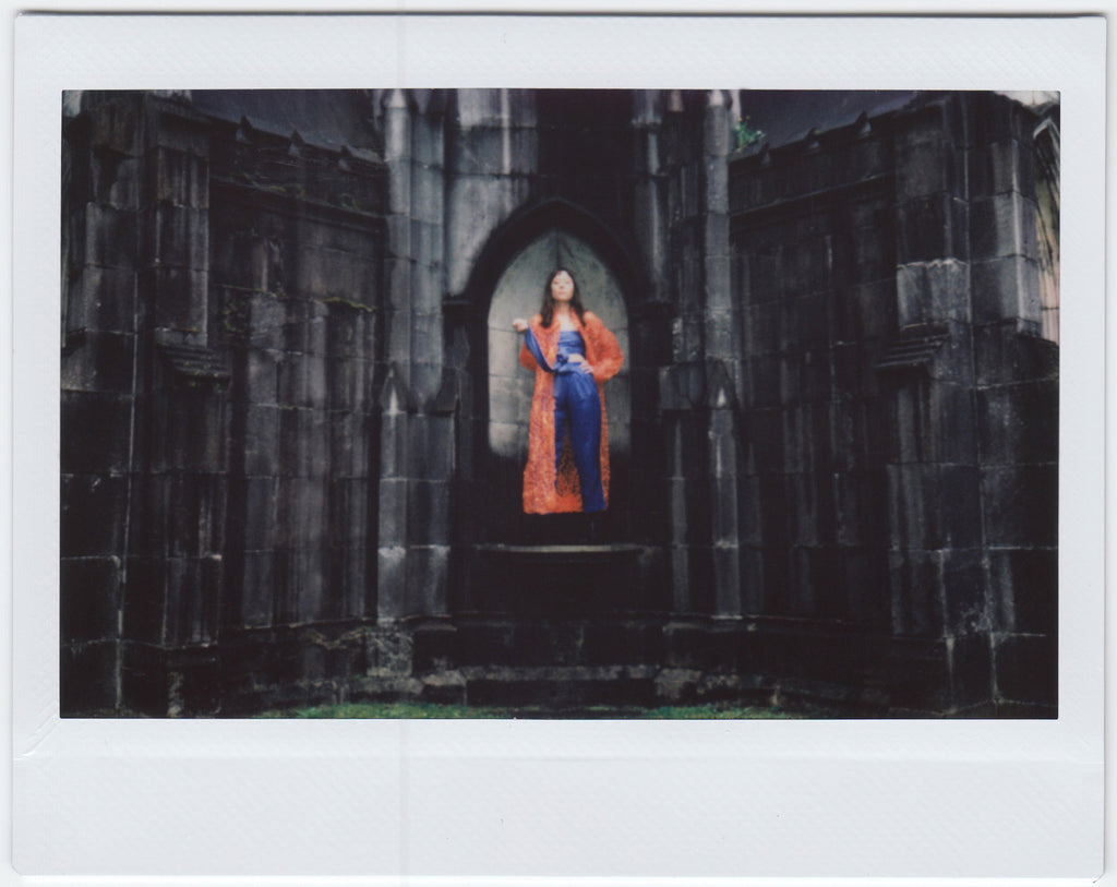 susy in front of stone building.