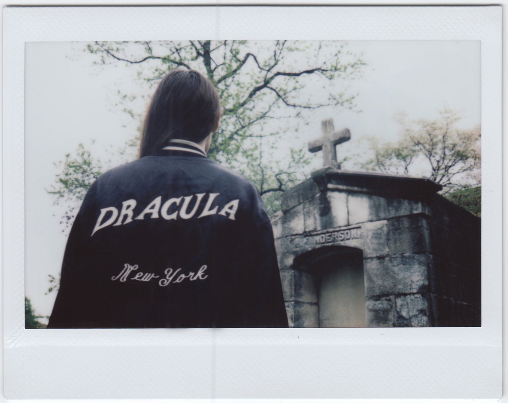 susy in starter jacket that reads daracula new york.