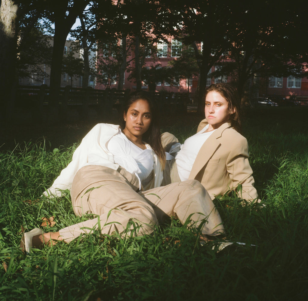 models in suits laying on ground.