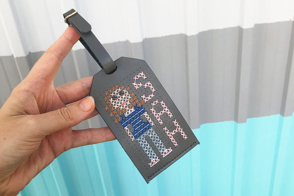 Stitch yourself luggage tag in grey cross stitch