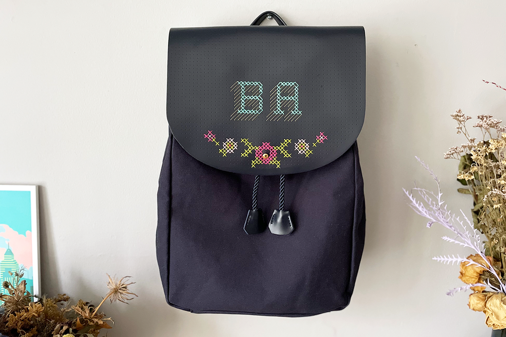 Stitched backpack with floral design and BA initials