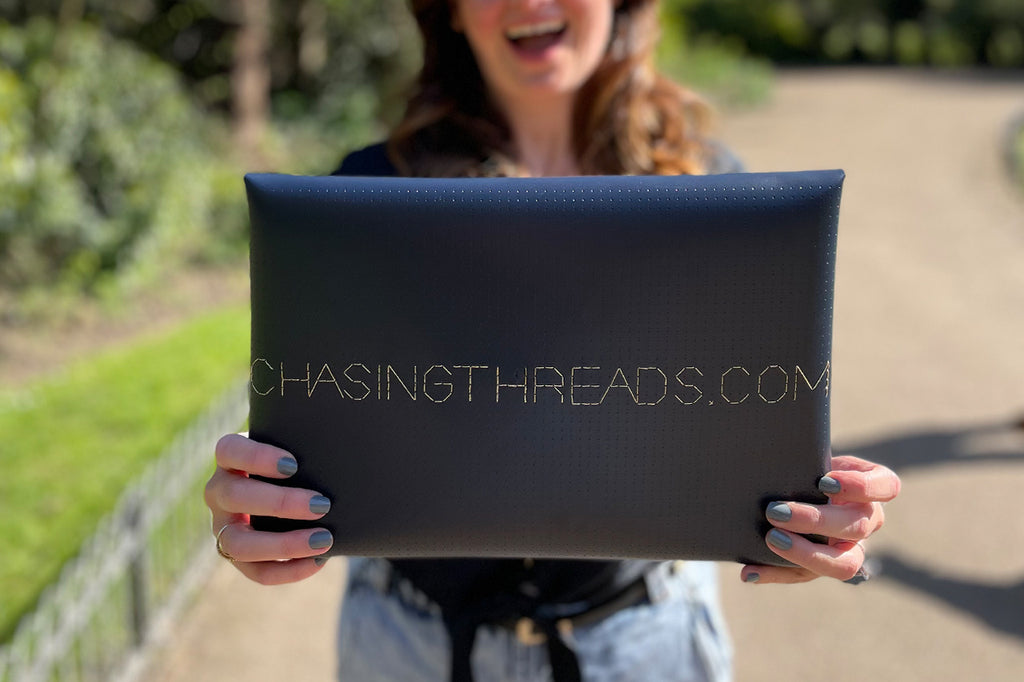 chasingthreads.com stitched on navy laptop sleeve