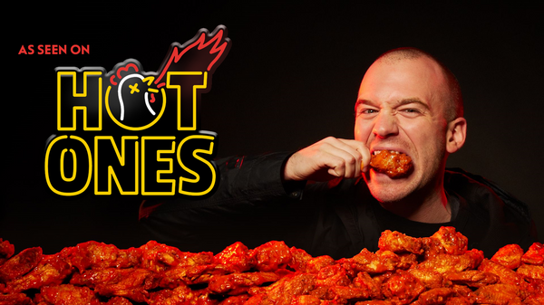 Sean Evans eats a chicken wing on his You Tube show Hot Ones