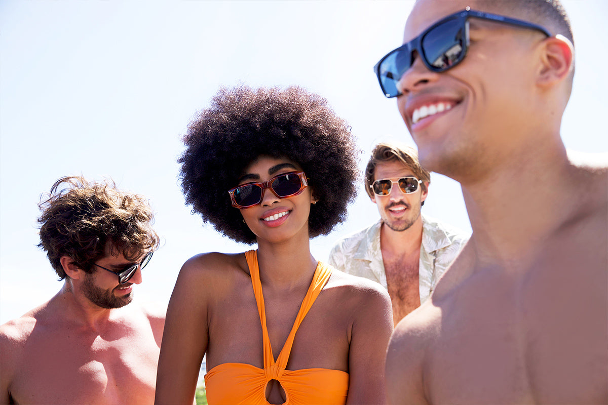 a women wearing prive revaux sunglasses on the beach