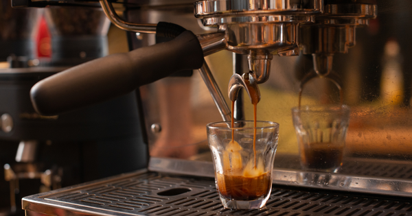 A shot of espresso being pulled from an espresso machine.