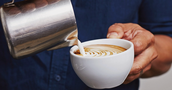 pouring cream in a coffee cup