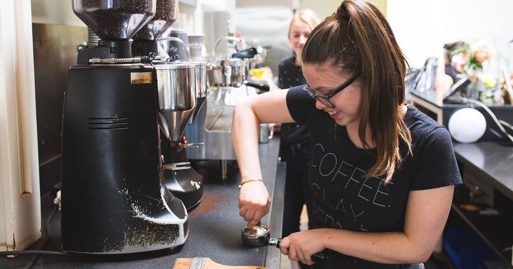 woman tamping coffee