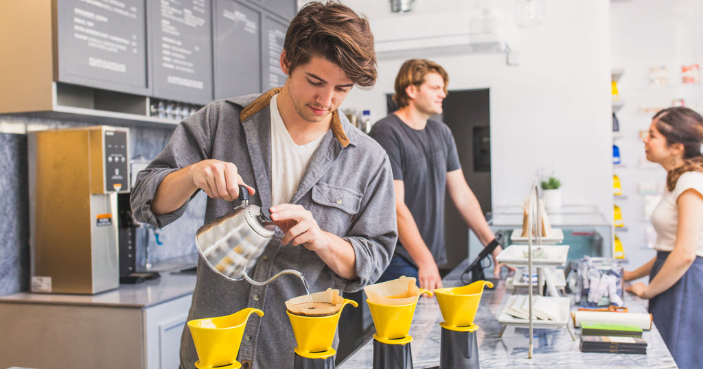 man making pour over coffee