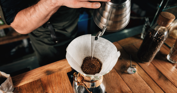 A person making a cup of coffee