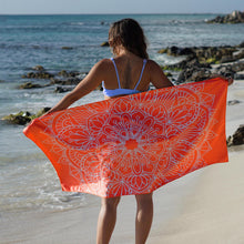 Load image into Gallery viewer, woman standing on shore with arms outstretched holding orange towel with mandala print