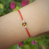 Adjustable slip knot bracelet with a birthstone crystal