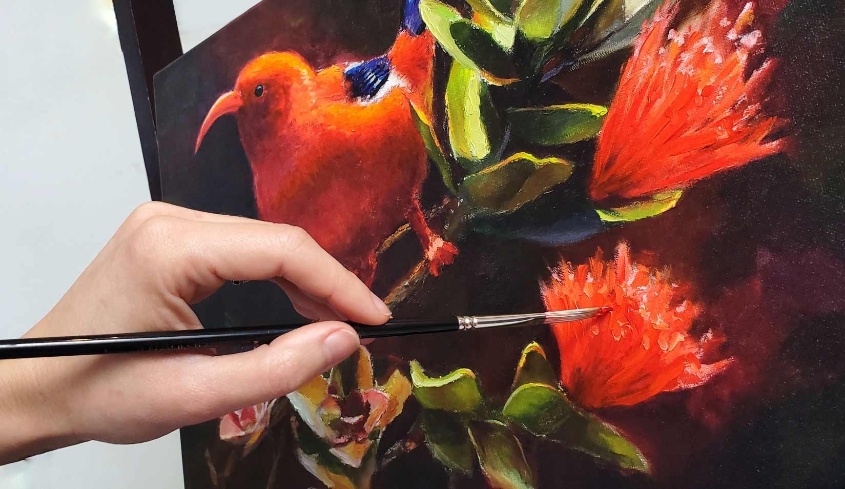 Karen Whitworth hand  enhancing canvas giclee print of iiwi bird and Hawaiian ohia lehua tree