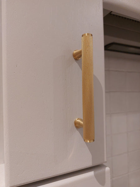 Posh Hardware Shop - Lulea brass handle pulls on white kitchen cabinet
