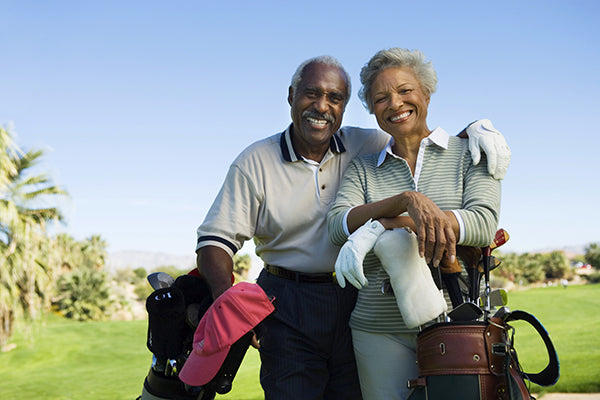 Couple playing golf. Smiling.