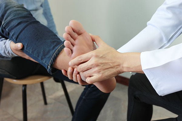 Close up of doctor examining feet.