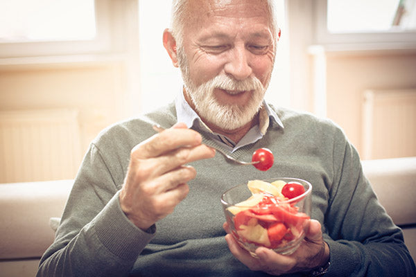 Man eating bowl of fruit