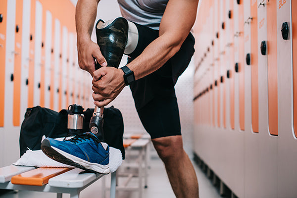 Man with prothesis in locker room