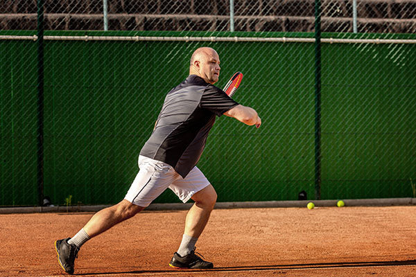 Man playing tennis.