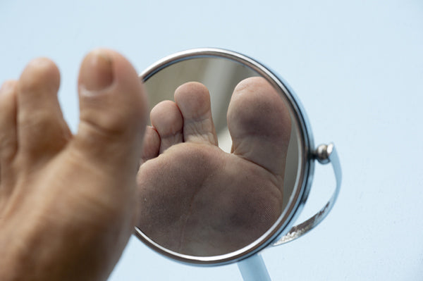 Foot examination in mirror.