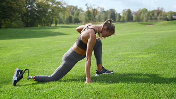 Woman with limb loss stretching - Lunge.