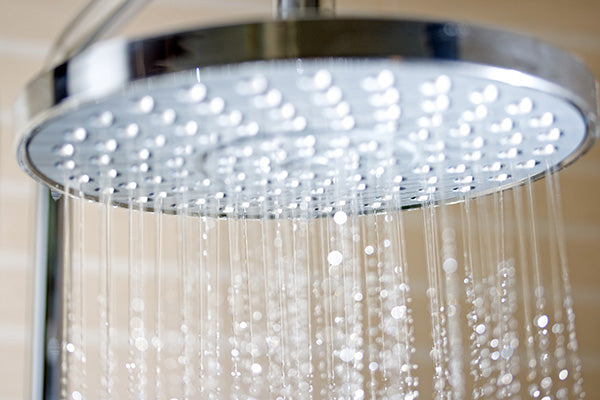 Image of shower head with water coming out.