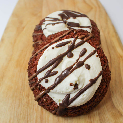 Sugar free red velvet cookies topped with cream cheese frosting and drizzled with chocolate, by Num Gourmet, Logan, Utah. keto friendly cookies sugar free red velvet keto friendly bakeries Utah sugar free desserts online orders ready to eat baked goods Utah bakeries Utah independent businesses keto life #ketofriendlytreats #ketofriendlycookies #ketoredvelvet #sugarfreetreats #cookies #redvelvet #ketodiet #ketobakeriesutah #utahbakeries #dontskipdessert #ketolifestyle #utahsmallbusiness