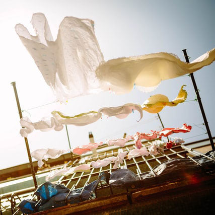 laundry hanging from lines shown from below