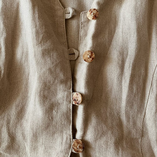 closeup of linen dress with button and loop closure