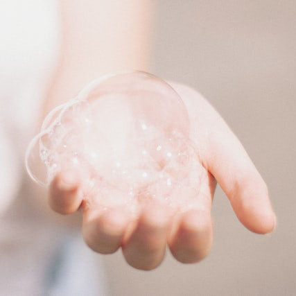 woman's hand holding bubbles