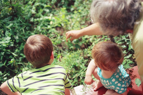 Adult with two small children outside