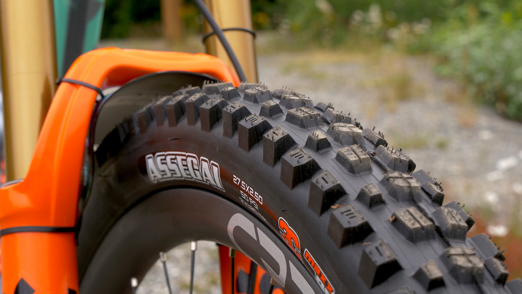 maxxis assegai mountain bike tire review on a shiny orange fox 36