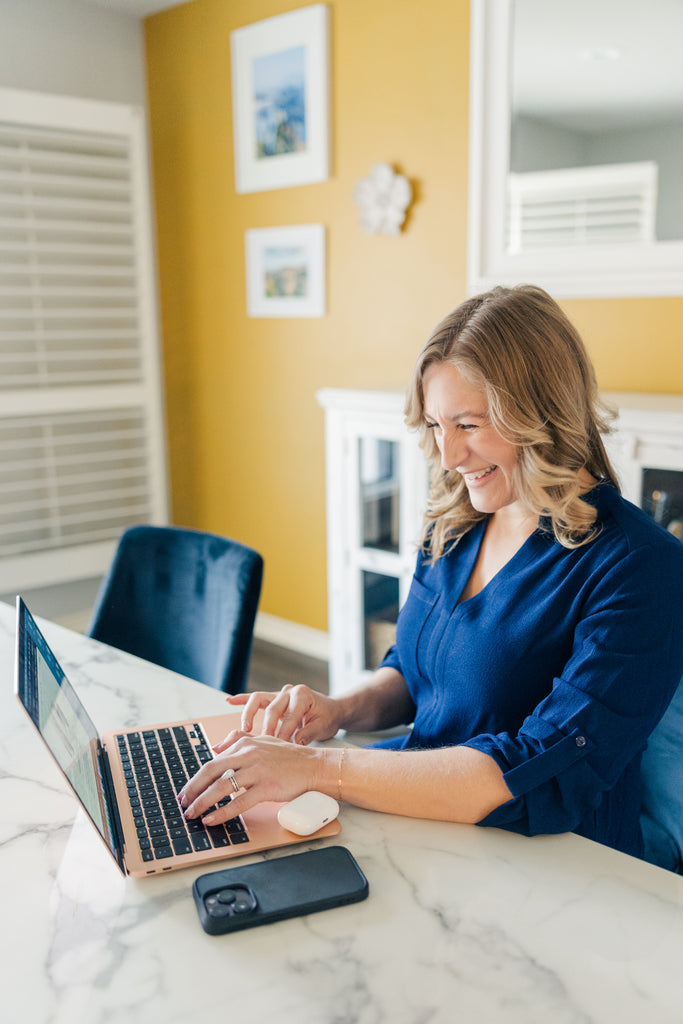 photo of a laughing Whitney on her computer